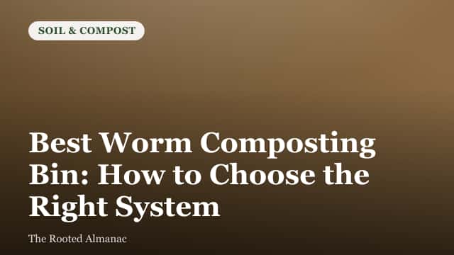 A stackable worm composting bin system sitting on a kitchen floor with a handful of finished compost nearby